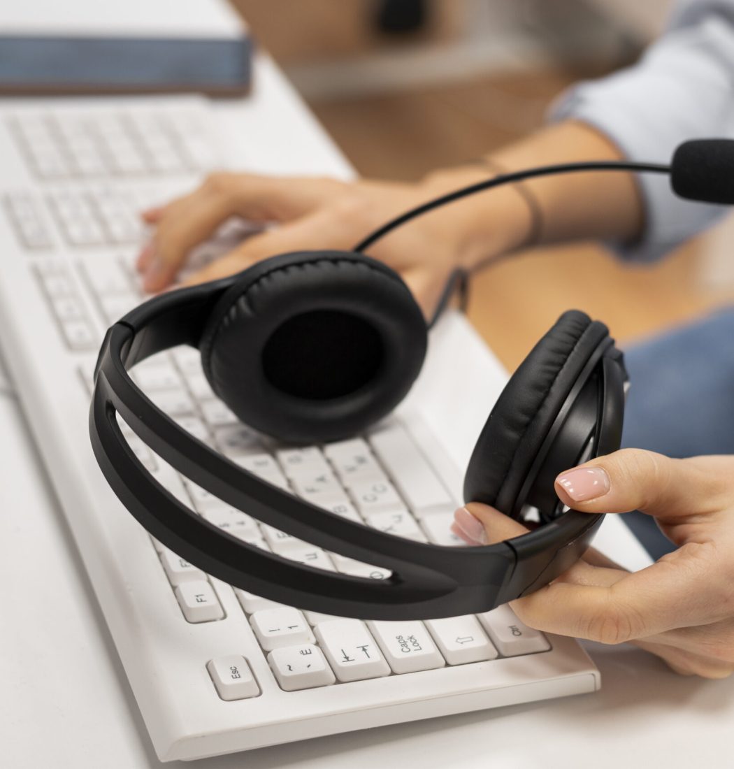 woman-working-call-center-holding-pair-headphones